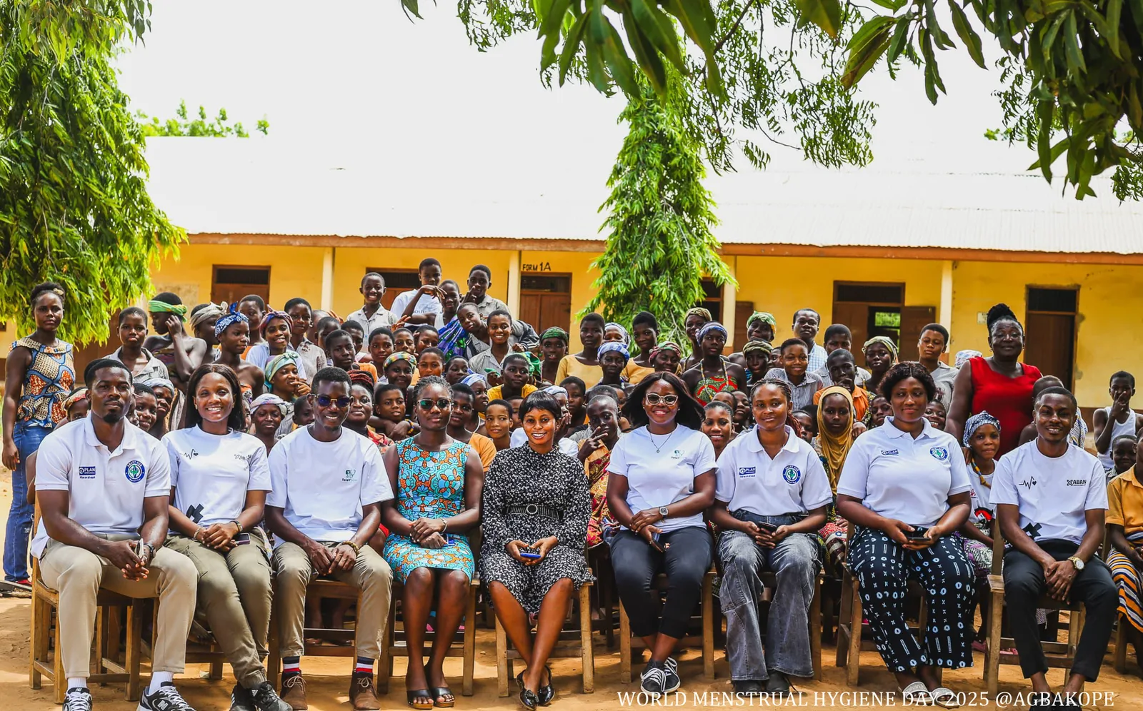 SMART Hub team and community participants gathered for a group photo outside a school.